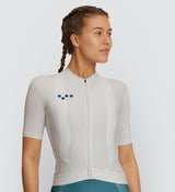 Front view of female cyclist wearing the Chalk Classic Cycling Jersey, showcasing breathable fabric and secure silicone hem