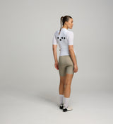 Front view of female cyclist in Core White Classic Jersey – extended sleeves, low-cut collar, and form-fitting silhouette designed for comfort and road performance.
