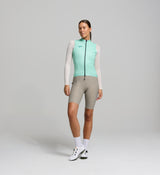 Front view of female cyclist in mint Classic LITE gilet – minimalist fit with wind-blocking fabric, SAB two-way zipper, and reflective chest detailing for visibility on early starts.