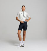 Front view of female cyclist wearing porcelain Classic LITE gilet – sleek fit with wind-blocking front panel, SAB two-way zipper, and reflective chest detail for visibility.