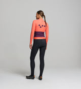 Rear view of midweight long sleeve cycling jersey in apricot – four-pocket system including side-wrap access, reinforced back panels, and a secure hem gripper for stability on longer cold-weather rides.