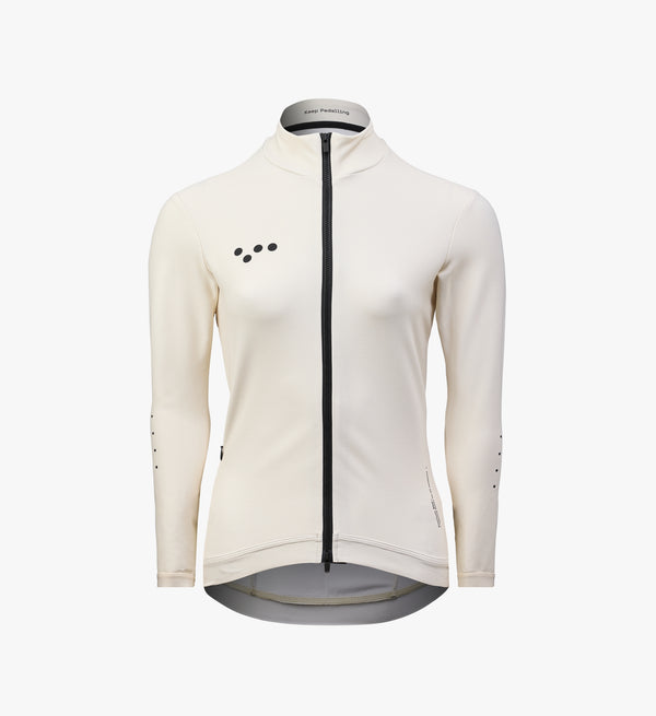 Women’s almond thermal long sleeve cycling jersey – insulated, moisture-wicking winter layer with brushed interior and breathable fit for cold-weather performance.
