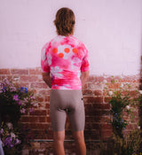 Back view of Floral Men's Classic Jersey - Cosmos on model, featuring extended sleeve design and rear pockets for functional ride storage