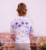 Back view of Floral Men's Classic Jersey - Daisy on model, showing extended sleeves and rear storage pockets designed for long-ride functionality