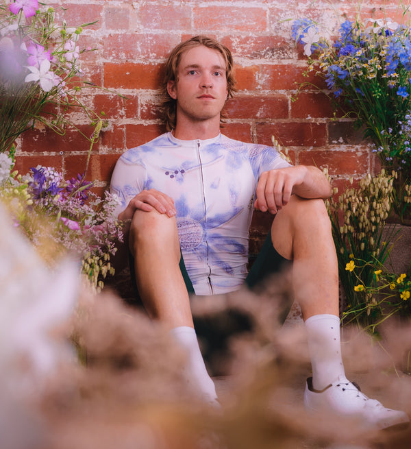 Model wearing Floral Men's Classic Jersey - Daisy front view, featuring low-cut collar and form-fitting silhouette for aerodynamic comfort