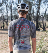 Back of Pedla SuperSYSTEM men’s gravel cycling jersey – reflective detailing and rear pockets built for off-road adventure riding