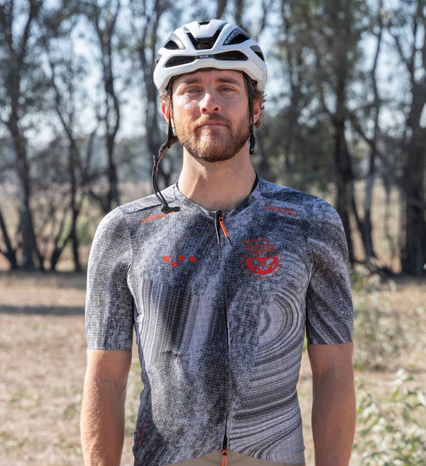 Front view of male cyclist wearing chrome SuperSYSTEM gravel jersey – ultralight woven fabric with bonded hem for long gravel rides