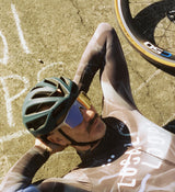 Side view of LOCAL LOOPS Men's Long Sleeve Cycling Jersey in Club Grey on model, highlighting the ergonomic fit, strategically placed ventilation panels, and four-way stretch fabric that provides flexibility, breathability, and all-weather protection during bike rides.
