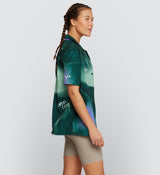 Back view of LOCAL LOOPS Unisex Beach Shirt in Race Pine on model, showcasing the breathable, perforated fabric and relaxed fit, symbolising Pedla’s commitment to comfort and quality in this limited edition cycling-inspired shirt.