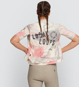 Back view of LOCAL LOOPS Women's Classic Cycling Jersey in Club Almond on model, featuring a tailored fit, extended sleeve length, and lightweight construction that enhance airflow and support for all-day comfort on road cycling adventures.