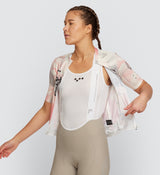 Front view of model wearing LOCAL LOOPS Women's Classic Cycling Jersey in Club Almond, highlighting the extended sleeve length, low-cut collar, and form-fitting silhouette for enhanced comfort and flexibility during long-distance and casual bike rides.