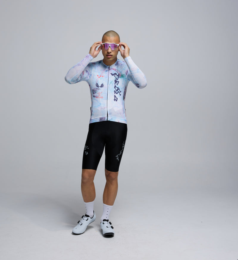 Front-facing image of male cyclist wearing Fade LS jersey, showing close fit, low collar, and extended sleeves for coverage.
