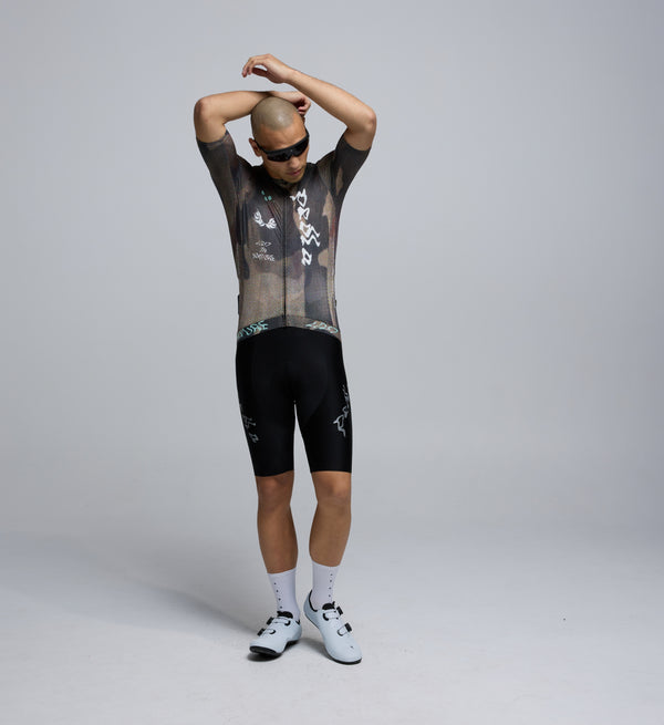 Front view of male cyclist in Dusty Training Jersey, highlighting low-profile collar, contoured cut, and extended sleeves.