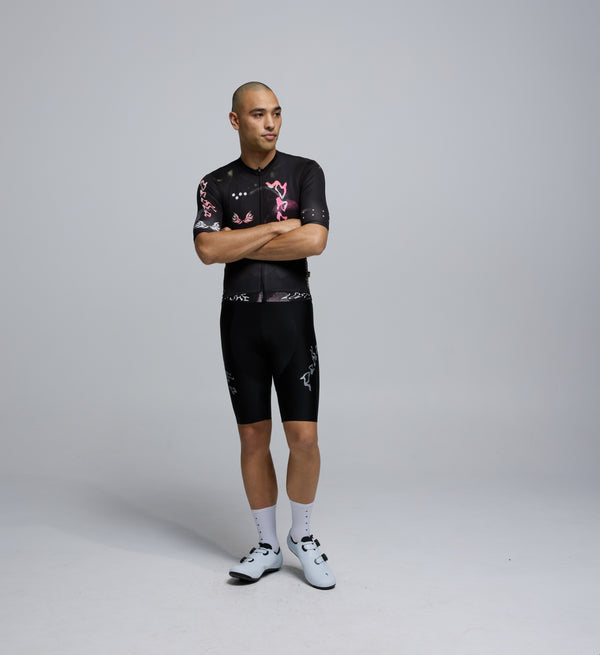 Front view of male rider in Wild Forest Training Jersey, featuring contoured fit, low collar, and extended sleeves.