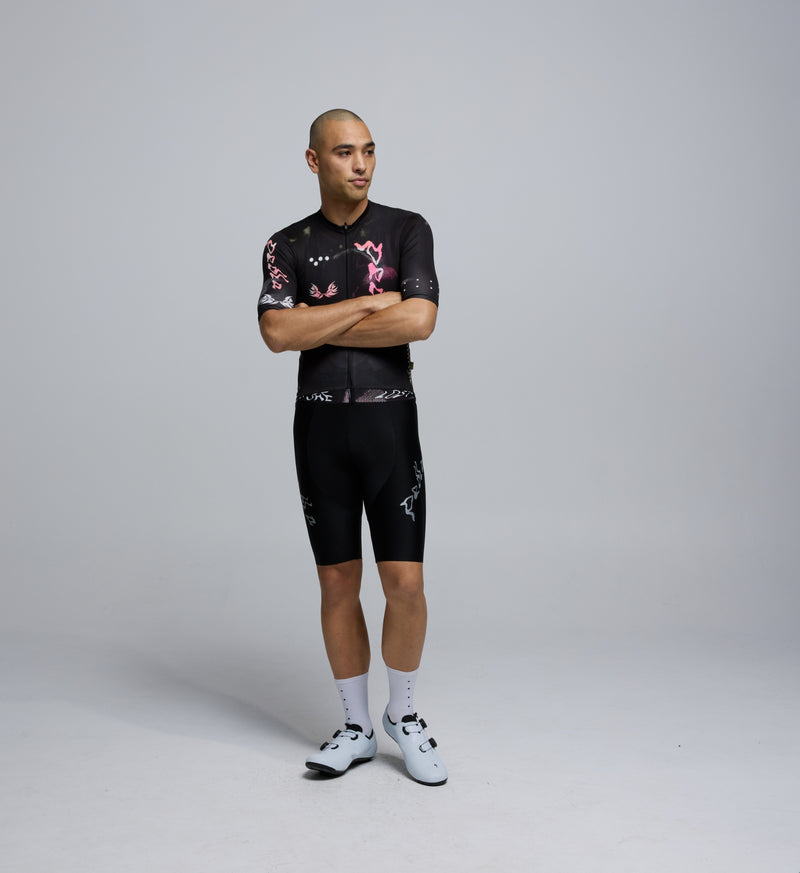 Front view of male rider in Wild Forest Training Jersey, featuring contoured fit, low collar, and extended sleeves.