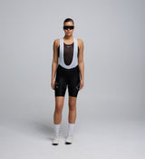 Female cyclist wearing black bib shorts from the Lost in Nature collection, showing supportive fit and seamless cuff design.
