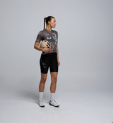 Side view of cyclist in dusty pink jersey – highlighting aerodynamic fit, micro-perforated side panels, and stretch fabric for training performance