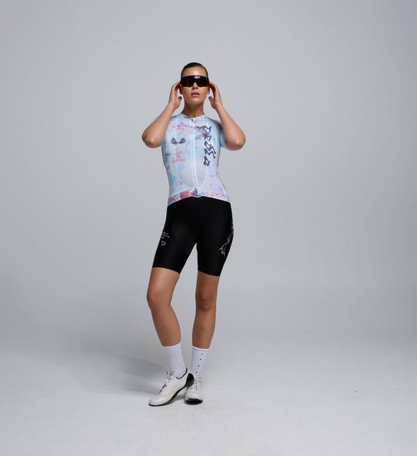 Front view of female cyclist in the Fade jersey, showing tailored fit, low collar, and breathable panelling.