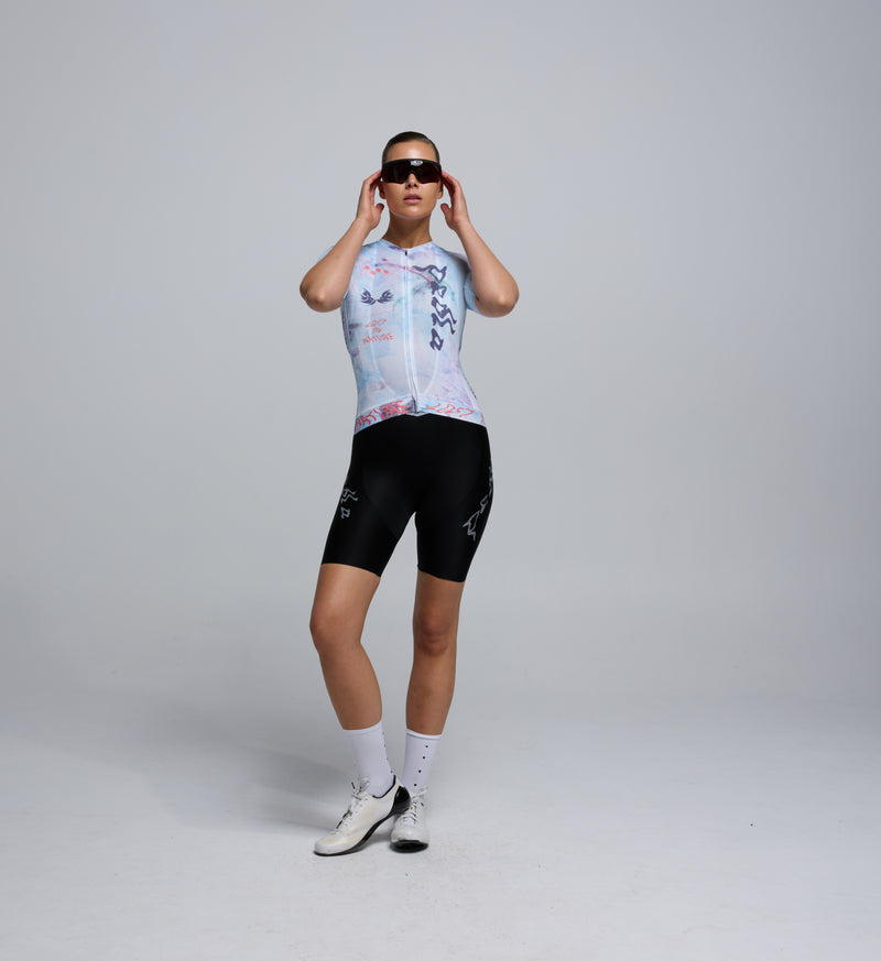 Front view of female cyclist in the Fade jersey, showing tailored fit, low collar, and breathable panelling.