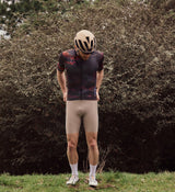 Front view of model wearing the NatureCAMO Men's Cycling Jersey in Acid, highlighting its form-fitting design, moisture-wicking properties, and low-cut collar that ensure comfort during long road rides and training sessions.