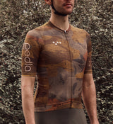 Close-up view of NatureCAMO Men's Cycling Jersey in Auburn on model, showcasing fabric texture, UPF/SPF 30+ sun protection, and microfiber materials that ensure moisture management and breathability during cycling.