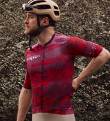 Close-up view of NatureCAMO Men's Cycling Jersey in Deep Pink on model, displaying the texture of the microfiber fabric, UPF/SPF 30+ sun protection, and four-way stretch for enhanced comfort and moisture management during cycling.