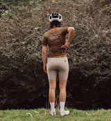 Back view of NatureCAMO Women's Cycling Jersey in Auburn on model, featuring breathable perforated panels and tailored design that provide comfort and support for intensive training and long-distance road cycling.