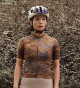 Close-up view of NatureCAMO Women's Cycling Jersey in Auburn on model, detailing the REPREVE® recycled fabric, UPF/SPF 30+ sun protection, and moisture-wicking properties for year-round cycling comfort and performance.