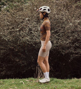 Side view of NatureCAMO Women's Cycling Jersey in Auburn on model, showcasing the ergonomic fit, four-way stretch fabric, and silicone gripper hem for enhanced airflow, flexibility, and performance during long cycling sessions or training circuits.