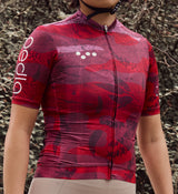 Close-up view of NatureCAMO Women's Cycling Jersey in Deep Pink on model, detailing the REPREVE® recycled fabric, UPF/SPF 30+ sun protection, and moisture-wicking properties for optimal cycling performance and comfort in any season.