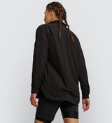 Back view of Black Off Grid Cargo Shirt on model, displaying durable felled seams and secure zip pocket for essential storage on the go.