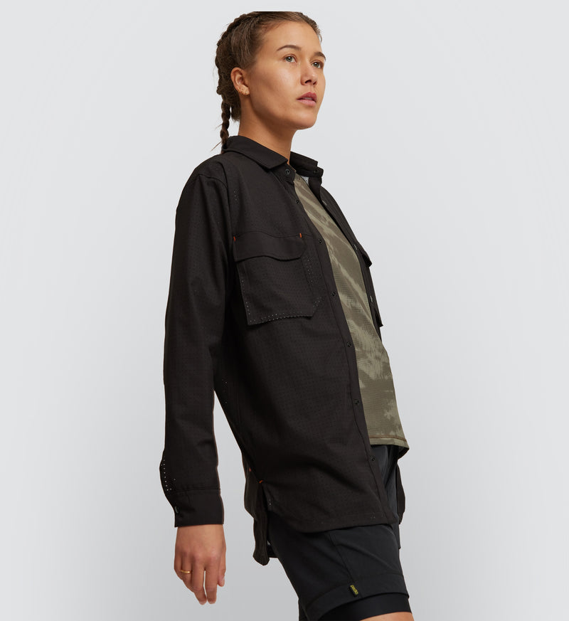Model wearing Black Off Grid Cargo Shirt front view, featuring relaxed fit and perforated fabric for maximum airflow and movement on cycling day.