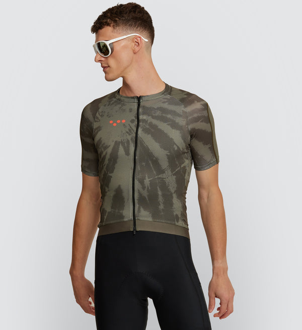 Front view of model in Khaki Dye Off Grid Men's Gravel Jersey, showcasing form-fitting design with mesh panels for optimal ventilation on gravel rides.