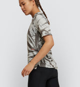 Side view of cyclist in Mono Tie Dye Off Grid Gravel Cycling Tech Tee, emphasizing durability and flexibility for off-road cycling adventures.