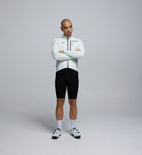 Front-facing view of a male cyclist wearing the Porcelain Deflect 2.0 Cycling Jacket, featuring a waterproof chest pocket, SAB® two-way zipper, and streamlined aerodynamic cut.