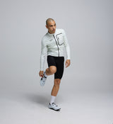 Side profile of the Men's Deflect 2.0 Cycling Jacket in Porcelain, showing flexible 4-way stretch side panels and underarms engineered for movement and comfort.