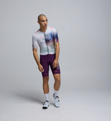 Front-facing view of a male cyclist wearing the AirFoils White Pro Pursuit Crit Suit, showcasing its ultra-sleek silhouette, low-cut collar, and breathable stretch-woven construction.