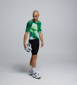 Side profile of the AirFoils Green Men's Pursuit 2.0 Cycling Jersey, showcasing mesh underarm panels for ventilation, heat-welded sleeve hems, and sleek aerodynamic shaping.