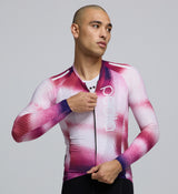 Close-up detail of AeroPRISMA sleeve fabric and welded hem on the Men's Pursuit LS 2.0 Jersey in AirFoils Hot Pink, emphasizing aerodynamic texture and premium Italian material quality.
