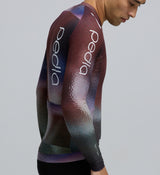 Close-up detail of AeroPRISMA bonded sleeve fabric and heat-welded hem on the Men's Pursuit 2.0 Long Sleeve Cycling Jersey in AirFoils Plum, illustrating the aerodynamic weave and precision finish.