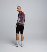 Side profile of the Men's Pursuit 2.0 Long Sleeve Cycling Jersey in AirFoils Plum, showing mesh underarm panels for ventilation and heat-welded sleeve hems for aerodynamic efficiency.