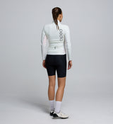 Back view of the Porcelain Deflect 2.0 Jacket, showcasing storm-flap-covered rear pockets, a dropped hem for coverage, and reflective accents for low-light visibility.