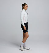 Side profile of the Women's Deflect 2.0 Cycling Jacket in Porcelain, highlighting the flexible 4-way stretch side panels and underarm zones for enhanced freedom of movement.