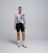 Front-facing view of a female cyclist wearing the Women's Pursuit 2.0 Jersey – AirFoils White, highlighting the sculpted silhouette, low-profile collar, and aero-focused sleeve design.