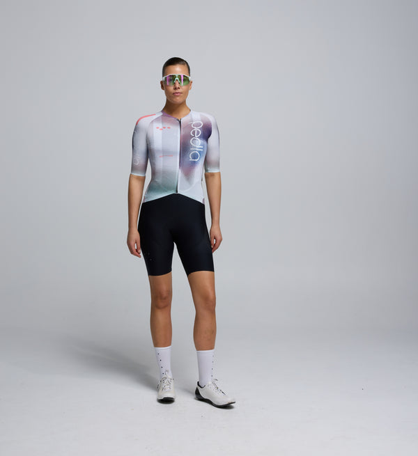 Front-facing view of a female cyclist wearing the Women's Pursuit 2.0 Jersey – AirFoils White, highlighting the sculpted silhouette, low-profile collar, and aero-focused sleeve design.