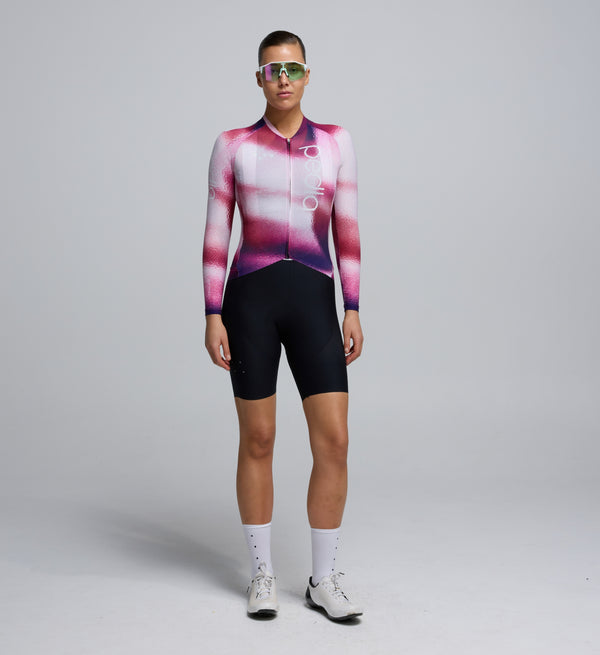 Front view of a cyclist wearing the Women's Pursuit LS 2.0 Jersey – AirFoils Hot Pink, highlighting the aerodynamic AeroPRISMA sleeves, sculpted race cut, and bold hot pink colour for visibility and style.