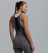 PRO SuperFit Air women's cycling bib tights — battleship grey rear close-up of ultra-light Italian 4-way stretch fabric, breathable mesh back panel, Elastic Interface 8+ hr road chamois, UPF 50+, iridescent reflective logos, small stash pocket