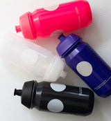 Four Pedla 500ml bidons in black, navy, olive, and sand; sustainable bottles with sleek design for modern cyclists