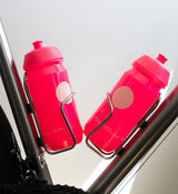 Pink Pedla bidon securely mounted in bike bottle cage; compact, accessible, and perfect for hydration on the move