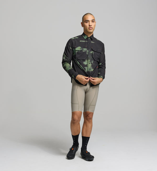 Front view of male cyclist wearing green cargo cycling shirt – relaxed fit and breathable woven fabric for warm weather rides